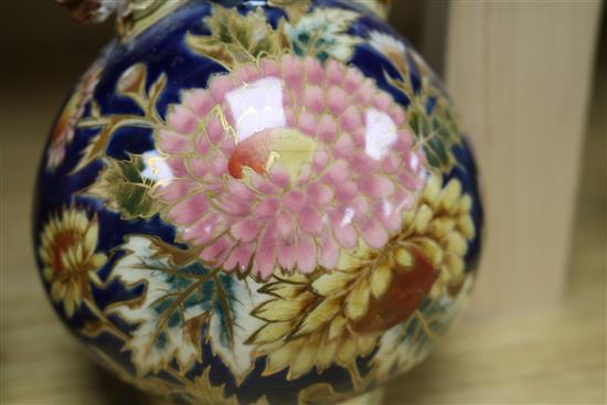 A pair of Zsolnay Pecs reticulated vases, floral-decorated on a blue ground and heightened in gilt height 20cm (a.f.)